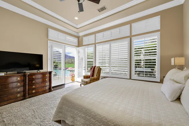 a bedroom with a bed and flat screen tv