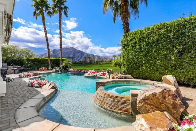 a front view of a house with garden and swimming pool