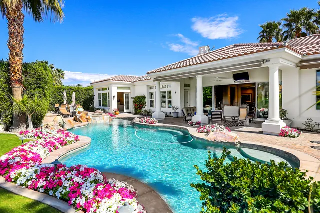 a view of a house with swimming pool patio and swimming pool