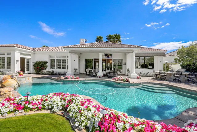 a view of a house with swimming pool garden and patio