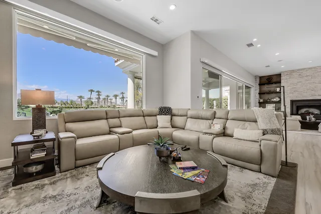 a living room with furniture and a fireplace