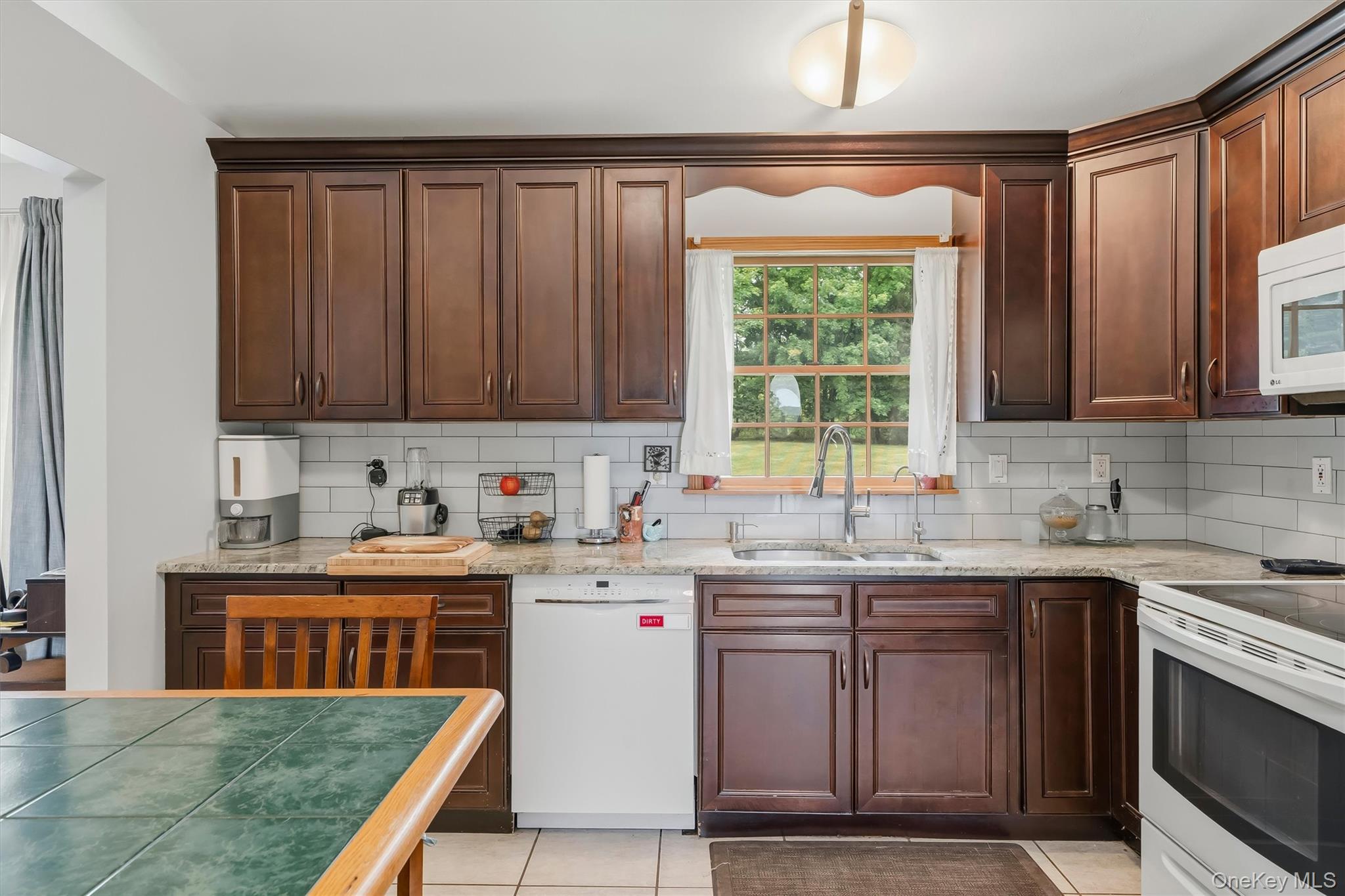 318 Beattie Road Washingtonville, NY 10992 - Photo 12 of 42 a kitchen with stainless steel appliances granite countertop a stove a sink dishwasher and a microwave oven on the blue kitchen countertops