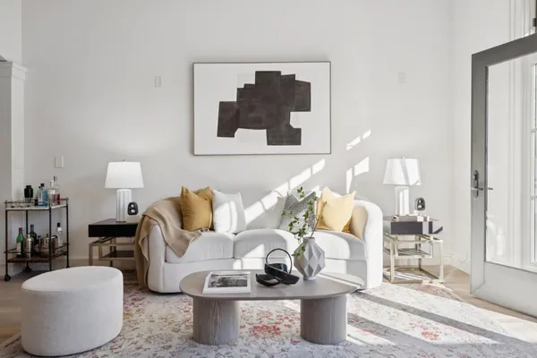 a living room with furniture and a lamp