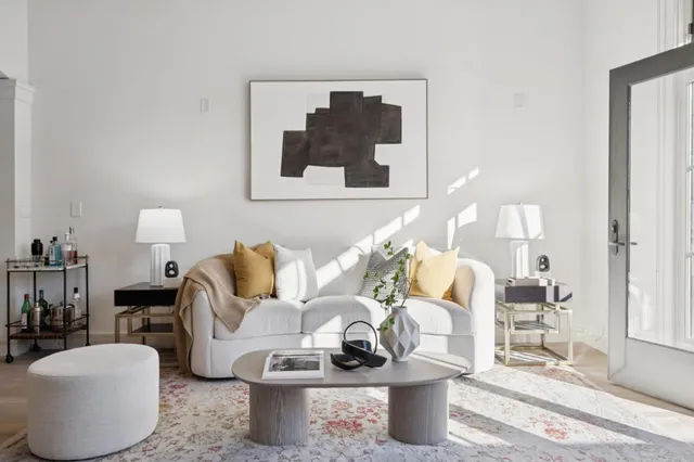 a living room with furniture and a lamp