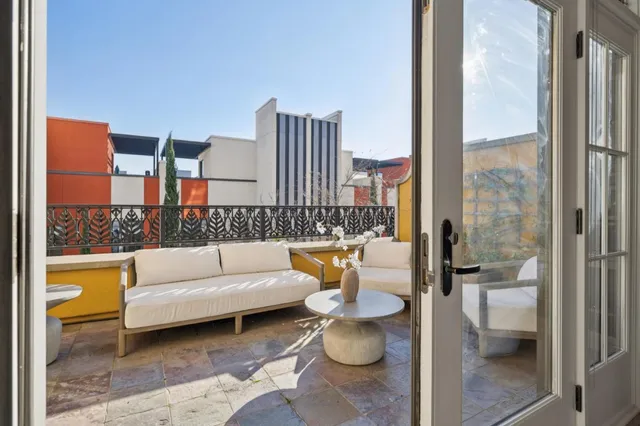 a living room with furniture and a floor to ceiling window