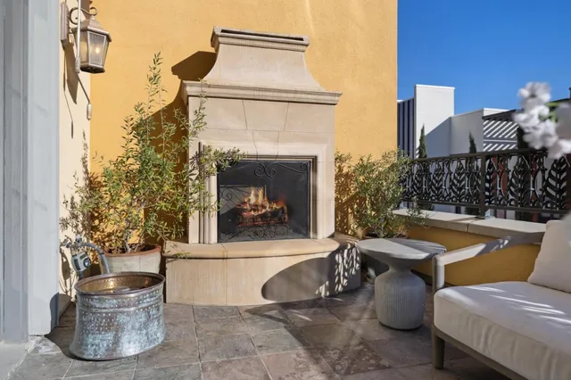 a view of a patio with couches table and chairs and potted plants