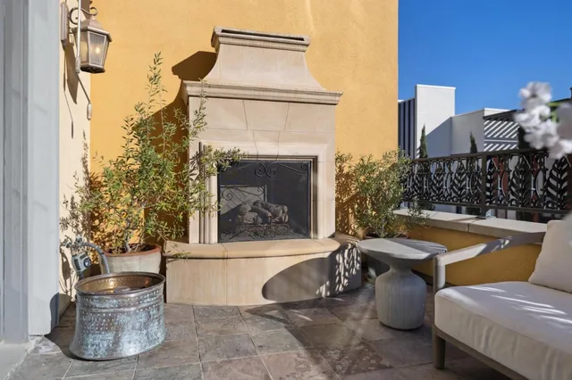 a view of a patio with couches table and chairs and potted plants