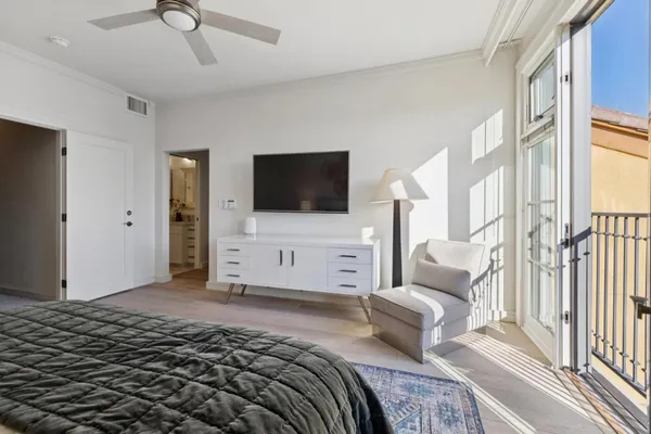 a bedroom with a bed and a flat screen tv