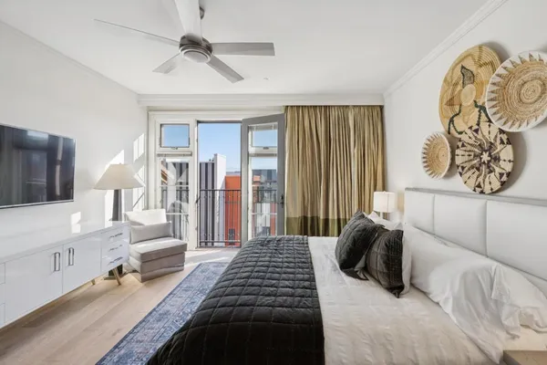 a bedroom with a large bed and a chandelier