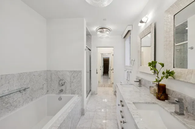 a bathroom with a bathtub sink and mirror