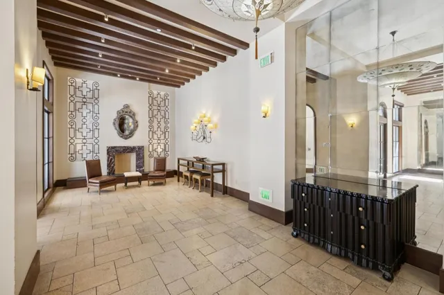 a view of a hallway with seating area and furniture