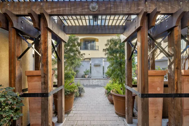 a view of a house with a potted plant and floor to ceiling window