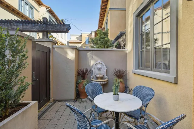 a view of a balcony filled with furniture and a potted plant
