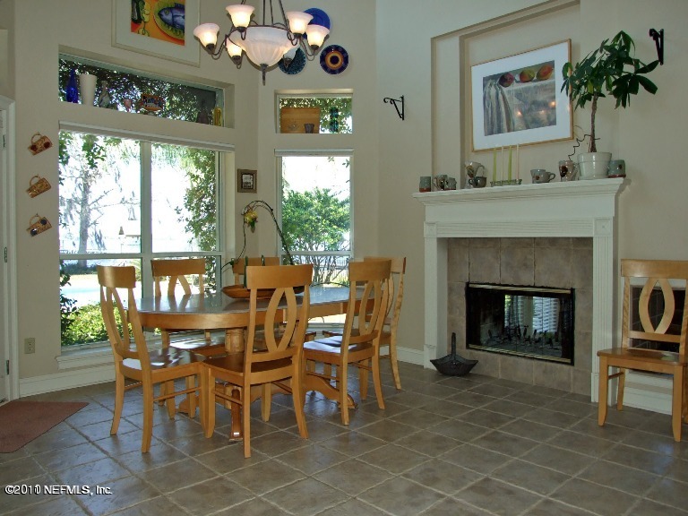 13120 Mandarin Road Jacksonville, FL 32223 - Photo 11 of 62 a dining room with furniture a fireplace and a large mirror