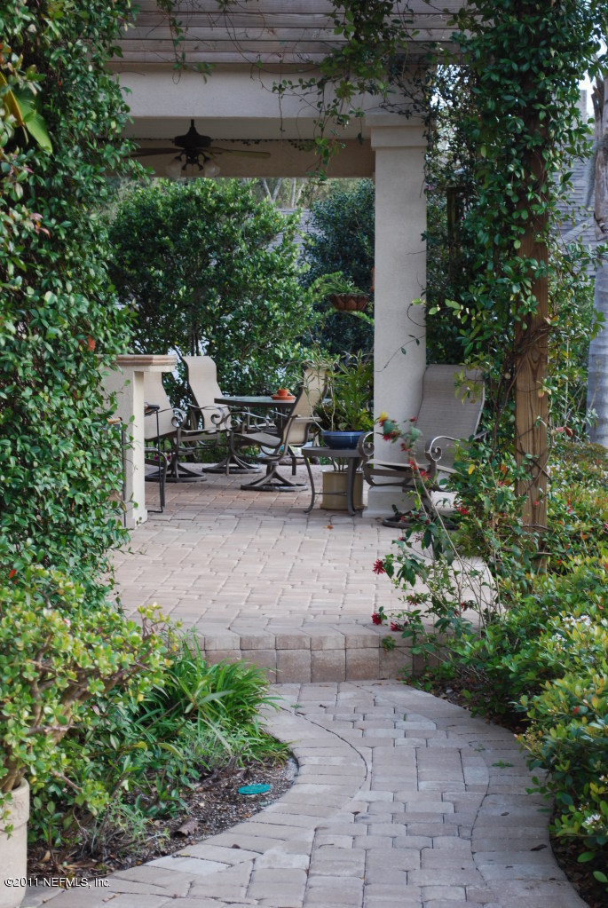13120 Mandarin Road Jacksonville, FL 32223 - Photo 17 of 62 a backyard of a house with outdoor seating and green space