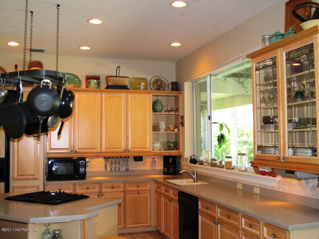 13120 Mandarin Road Jacksonville, FL 32223 - Photo 28 of 62 a kitchen with a sink a stove and a window