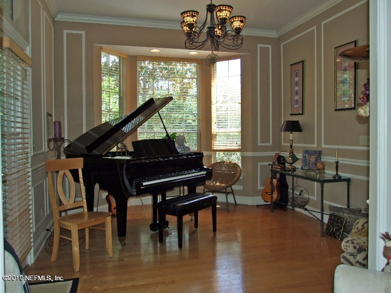13120 Mandarin Road Jacksonville, FL 32223 - Photo 7 of 62 a living room with furniture a window and a chandelier