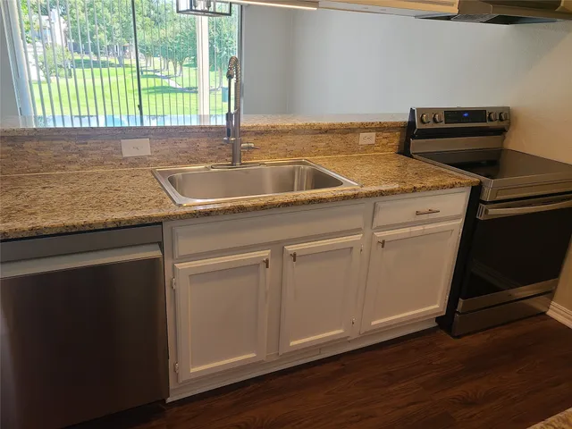 a kitchen with a sink and cabinets