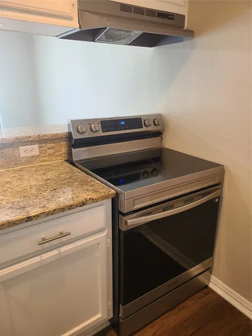 a stove top oven sitting inside of a kitchen