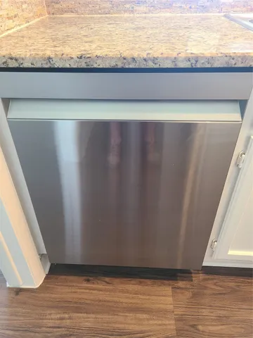 a view of a closet with wooden floor