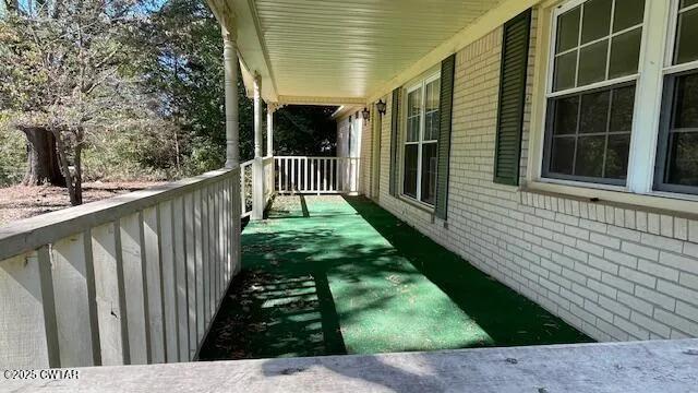 a bathroom with a sink a mirror and painting on the wall