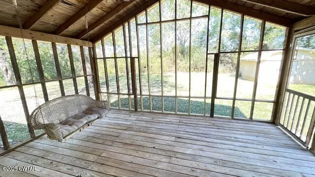 wooden floor in an empty room with a fireplace