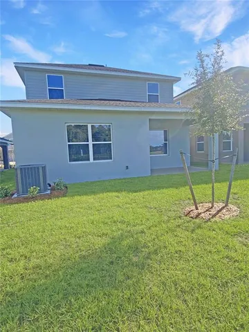 a view of a house with a yard and garage