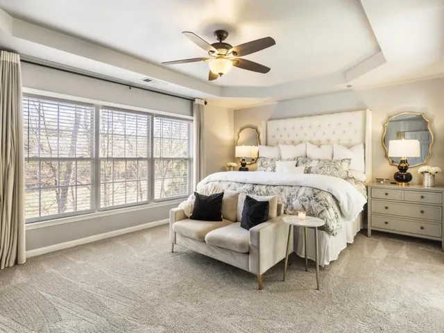 a bedroom with a bed couch and window