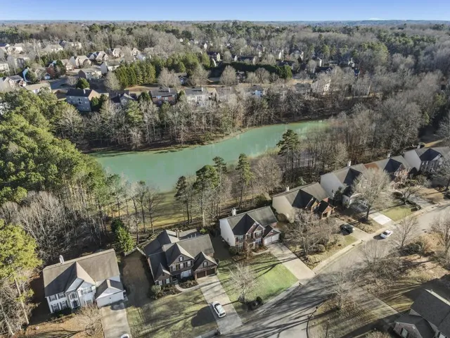 an aerial view of a house with a yard