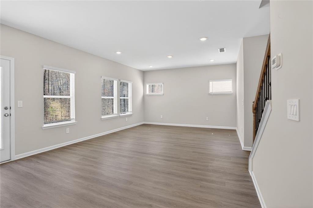 6929 Winchester Place Fairburn, GA 30213 - Photo 13 of 35 an empty room with wooden floor and windows