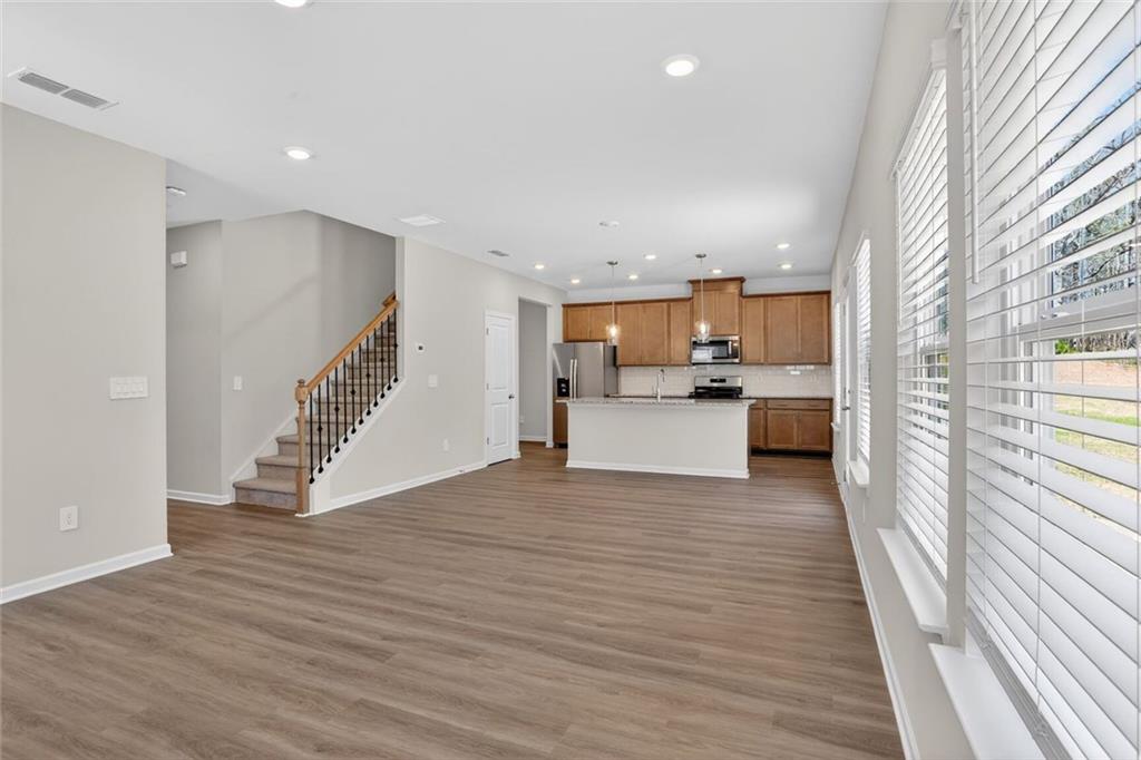 6929 Winchester Place Fairburn, GA 30213 - Photo 15 of 35 a view of a kitchen with wooden floor and electronic appliances