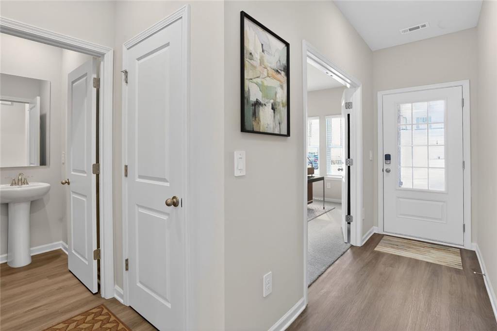 6929 Winchester Place Fairburn, GA 30213 - Photo 2 of 35 a view of a hallway with wooden floor and a bathroom