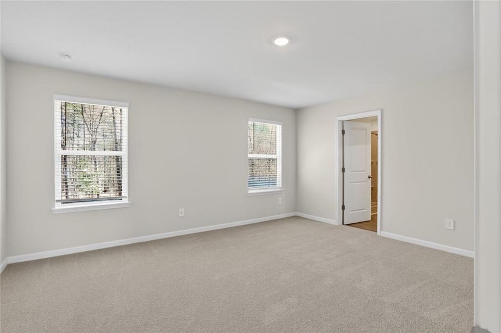 6929 Winchester Place Fairburn, GA 30213 - Photo 21 of 35 an empty room with windows