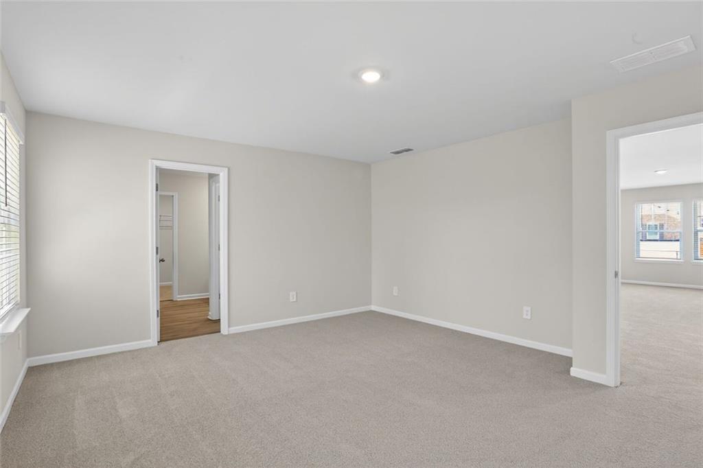 6929 Winchester Place Fairburn, GA 30213 - Photo 22 of 35 an empty room with windows and closet
