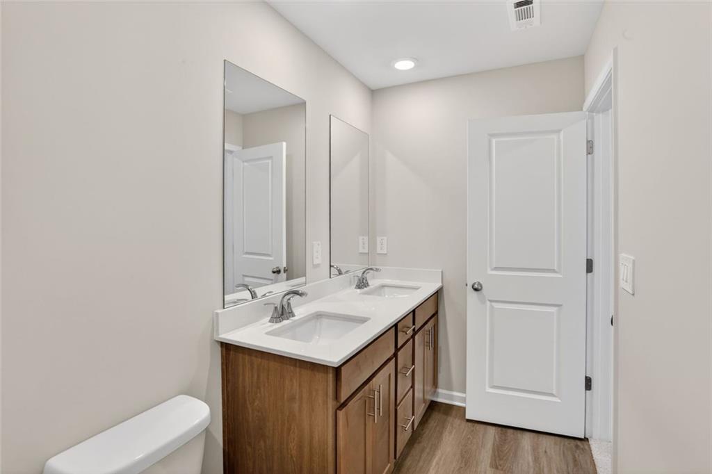 6929 Winchester Place Fairburn, GA 30213 - Photo 27 of 35 a bathroom with a sink and a mirror