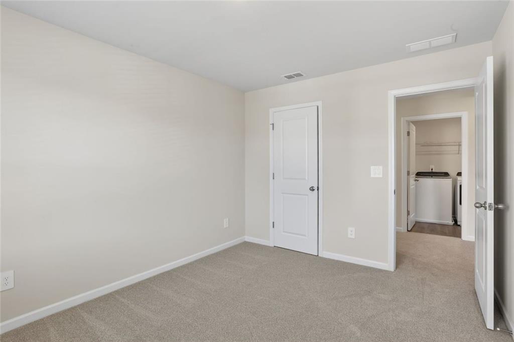 6929 Winchester Place Fairburn, GA 30213 - Photo 29 of 35 wooden floor and closet in a room