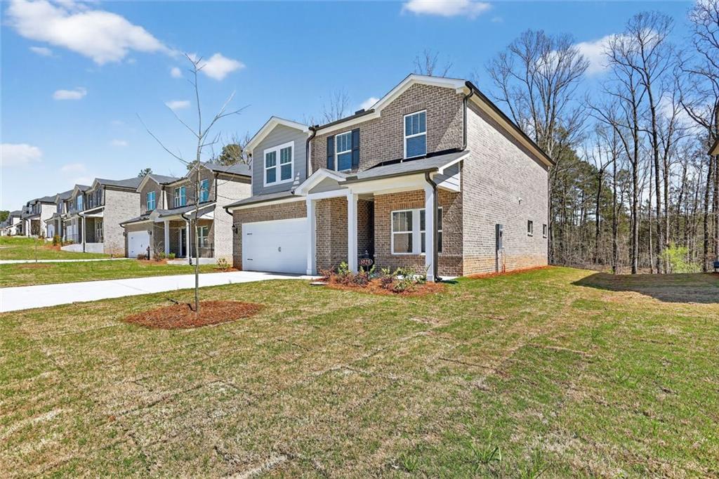 6929 Winchester Place Fairburn, GA 30213 - Photo 33 of 35 a front view of a house with a yard