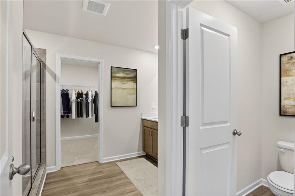 6929 Winchester Place Fairburn, GA 30213 - Photo 10 of 35 a view of hallway with bathroom and wooden floor