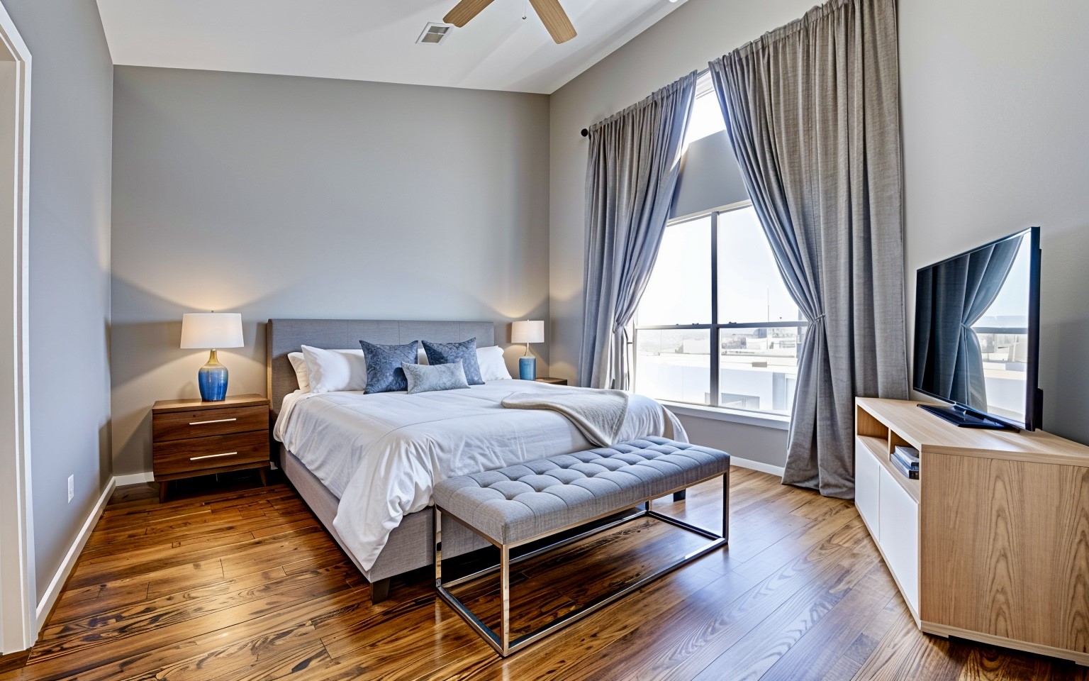 a bedroom with a bed and wooden floor