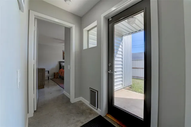 a view of a bathroom from a corridor