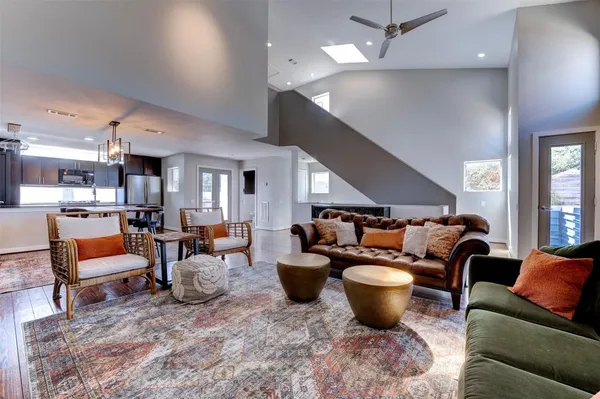 a living room with furniture a rug and a chandelier