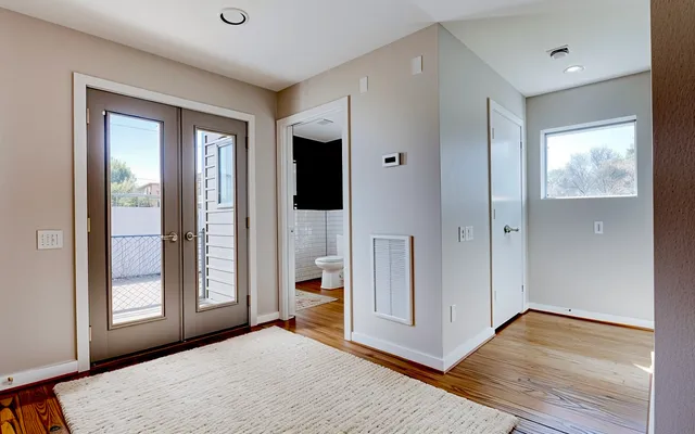 a view of an empty room with glass door and a window