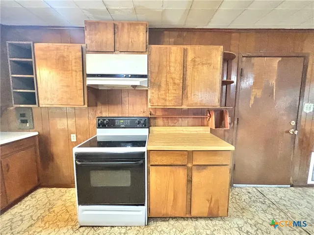 a kitchen with refrigerator a washer and dryer