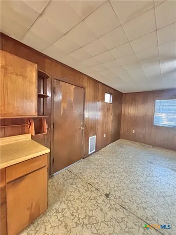 a view of a hallway with a kitchen
