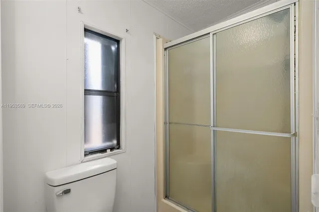 a bathroom with a shower and a toilet