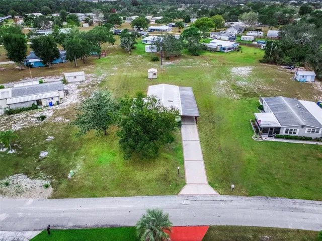 an aerial view of a house with yard