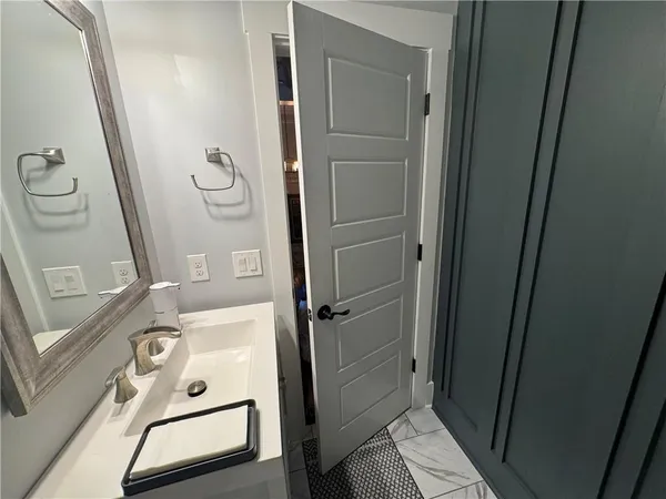 a bathroom with a tub a sink and a mirror