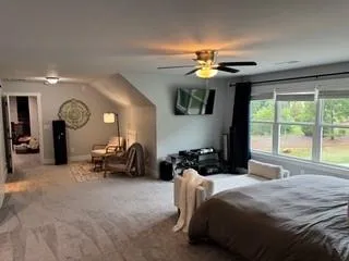 a bedroom with furniture and a large window