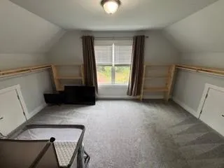 a view of an empty room with a window