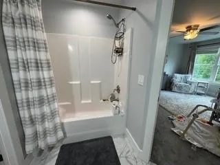 a bathroom with a bathtub and shower